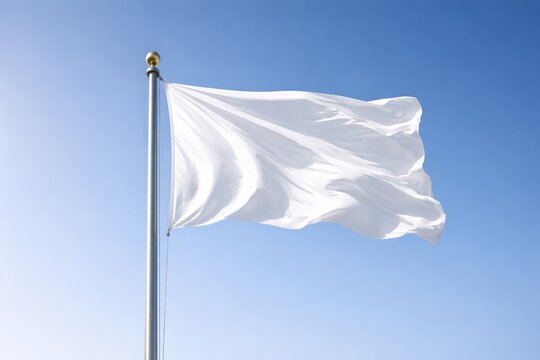 A billowing white flag atop a high flagpole set against a cloudless sky background