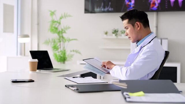 doctor  working in office,  reading medical document, focused senior therapist physician  wearing doctor gown sitting at desk in hospital, analyzing patient diagnosis or report.