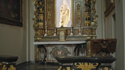 Ornate church altar softly defocused interior background with gilded statue and carved wood details  background backplate backdrop calm. © Krakenimages.com
