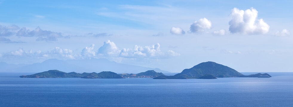 Panoramic view of small Island group Les Saintes with small town Terre-de-Haut (Caribbean island Guadeloupe) in front of Dominica from viewpoint near Trois-Rivieres 