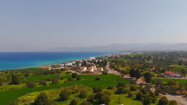 Aerial Pan from Lush Green Cultivated Fields to Mediterranean Sea Latsi Coastline