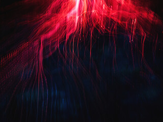 Title: Abstract red neon light trails and flowing glowing streaks on dark background with futuristic energy and long exposure motion effect © blackday