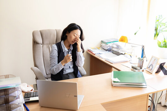 Small business owner experiences financial crisis, high costs, bank debt, money overspend concept. Asian woman sitting at desk looks at laptop screen holding receipt feels desperate after calculating 