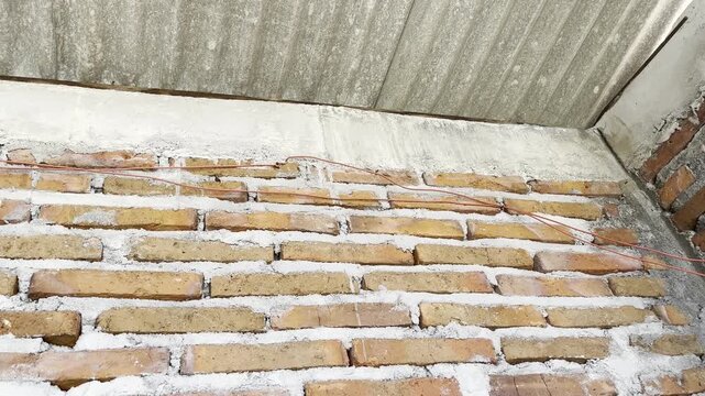 Close-up of Red Brick Wall and Corrugated Roof Interface