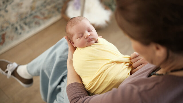 Photographer Wraps Newborn For Photo Shoot