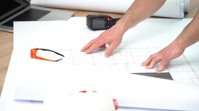 An engineer works with drawings on a construction project. working with project documentation. High quality FullHD footage