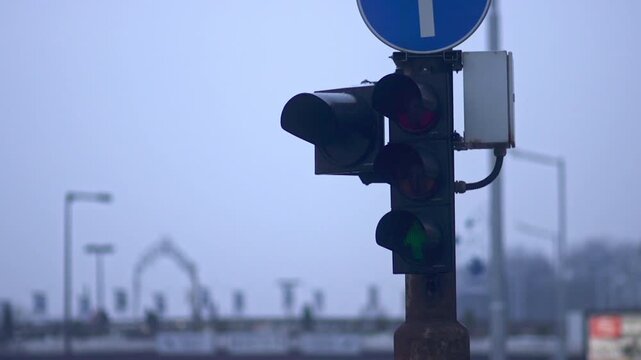 4K winter shot at dusk (evening) with apartment buildings, cars and trucks on the road, lights and traffic signs and lights in the city center of Sofia, Bulgaria in the Balkans, Eastern Europe, EU.