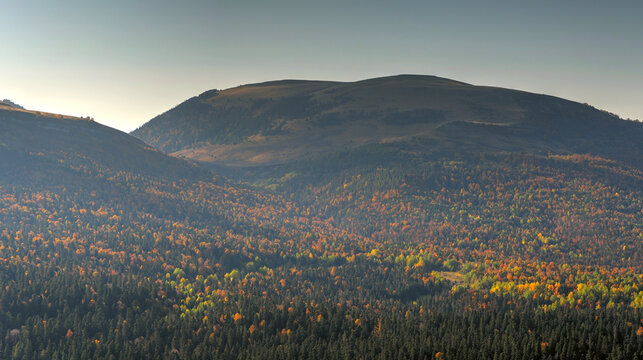 The photo shows a beautiful autumn landscape of the Caucasus Mountains
