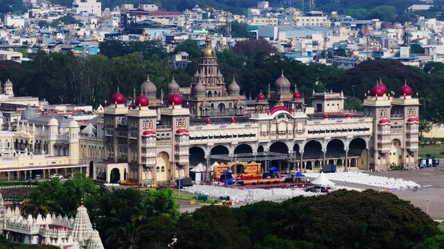 close up shot of Mysuru Palace with gold plated dome , temple and residential buildings at mysore, karnataka, india. day time, push back shot, drone shot, 4k.