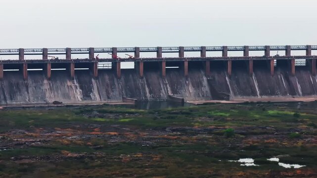 Close up shot of Tungabhadra dam with open gate and sky at Munirabad, Hosapete, Karnataka, india. day time, trucking shot, drone shot, 4k.