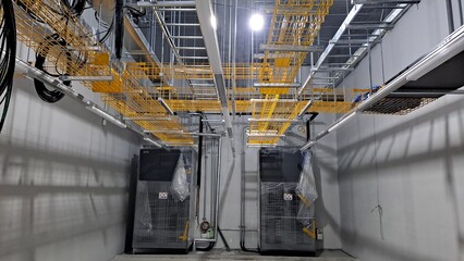 yellow mesh cable trays and infrastructure in a data center meet me room mmr under construction © Memory