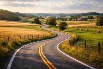 Naklejka premium Tranquil scenic road twisting through wide open farmland