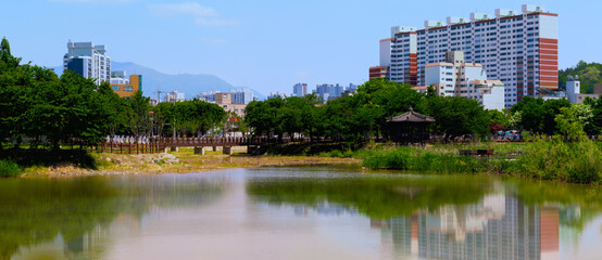 Fototapeta premium Gwangju Metropolitan City green space spring landscape at Uncheon Lake Park in Jeollanam‑do, South Korea, a panoramic view