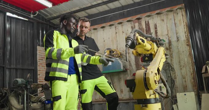 Supervisor Coaches Technician on Robotic Arm Maintenance with Technical Guidance