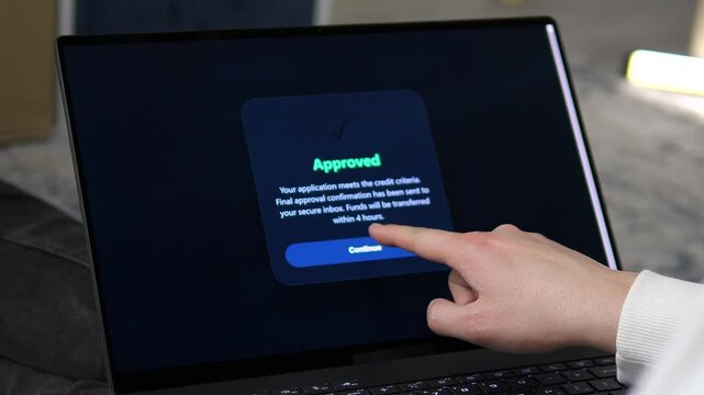 Modern online banking in action. Close-up of an approved credit status on a high-end laptop. Ideal for mortgage, lending services, and financial app commercials. High-quality footage that reflects