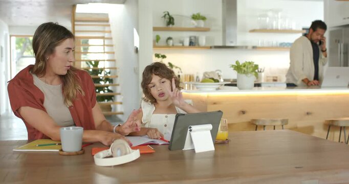 Family woman reviewing workbook at home, guiding girl's fingers and pointing at tablet for learning