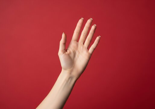 Woman's hand raised with fingers spread on red background for blm Ups