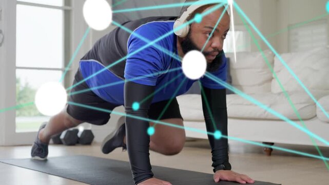 Man starting, performing alternating knee drives on mat at home, AR nodes tracking form for fitness