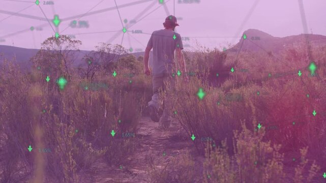 Male hiker walking dirt path, starting green data overlay growing then fading while mapping terrain