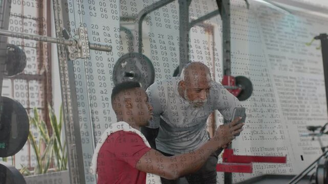 Gym client holding phone, trainer leaning, overlay across frame then clearing, both reviewing stats