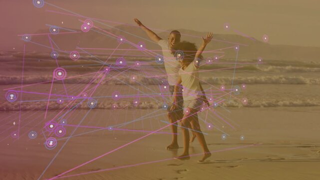 Dad and daughter starting arms wide walking and playing along sand tech overlay forming around them