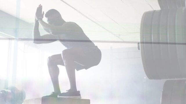 Man shifting swinging exploding onto plyo box landing stabilizing for fitness with motion lines