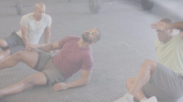 Central man shifting onto right hand, lowering back and bridging, pedaling for gym core, barbells