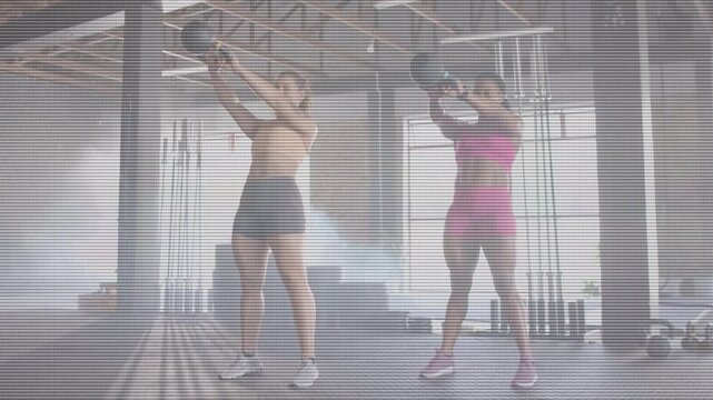 Female duo starting hip hinge and swinging kettlebell overhead, animated overlay guiding training
