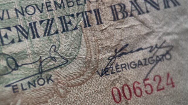 Close up video showing the engraved male portrait detail on a vintage Hungarian 1 million pengo banknote from 1945. The footage emphasizes fine linework, facial engraving, and aged paper texture.