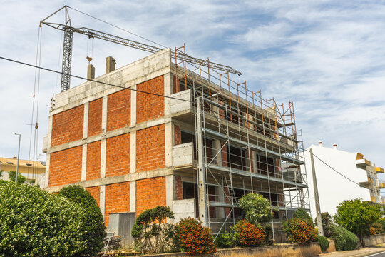Modern apartment building under construction beside urban street