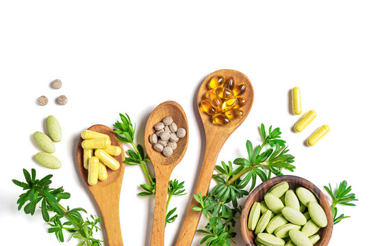 Natural vitamins, plant based supplements and green leaves