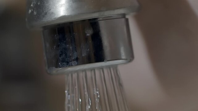 Turning off the water faucet in a dirty clogged bathroom sink