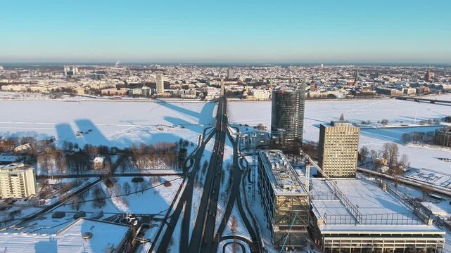 Panoramic aerial shot of Riga capital of Latvia during cold winter season with frozen river