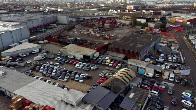 Car park, workshops, and warehouses in an industrial zone in suburbs of Paris, France. Aerial drone