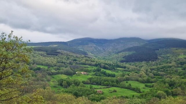 Mountainous landscape with green hills, forests, and cloudy skies in candelario, salamanca, spain