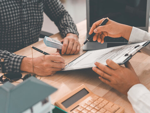 Signing a home purchase agreement with a reputable real estate agent and handling legal paperwork; concepts related to buying, selling, renting, investing, and the housing market.