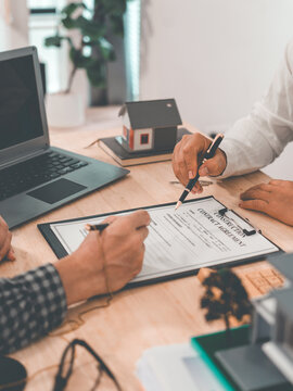 Signing a home purchase agreement with a reputable real estate agent and handling legal paperwork; concepts related to buying, selling, renting, investing, and the housing market.