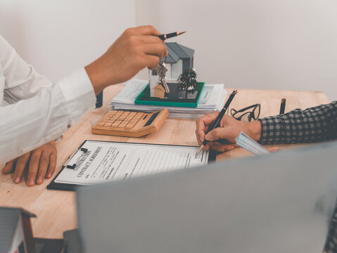 Signing a home purchase agreement with a reputable real estate agent and handling legal paperwork; concepts related to buying, selling, renting, investing, and the housing market.