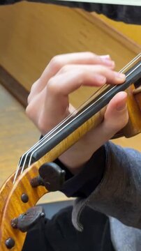 Close up violin playing performance, musician hands on strings and bow isolated framing, classical instrument music concept