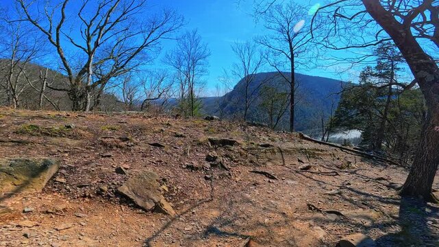 Panoramic mountain vista from rocky summit of Mount Tammany. Wide view of forested ridges and clear blue sky from a high elevation rocky plateau.