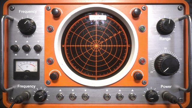 An electronic device with a large dial and buttons is shown on a table indoors closeup.