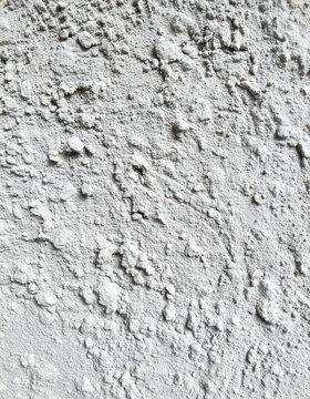 Unfinished cement plaster wall surface, raw construction material texture