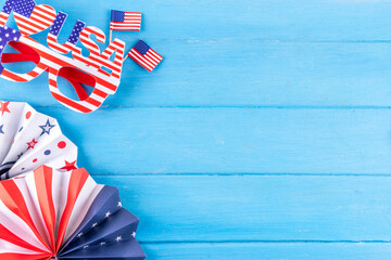 Obraz premium Light blue wooden USA Patriotic, Independence Day Fourth of July background with American Flag, party and picnic accessories, top view copy space