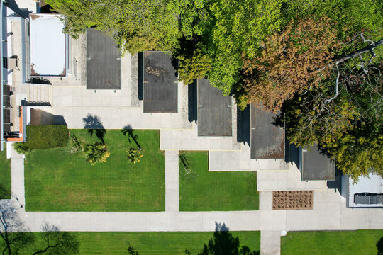 Aerial view of modern architecture featuring flat roofs, green lawns, and lush trees in Morges, Vaud, Switzerland.
