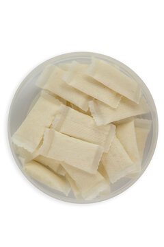nicotine pouch snus white portion small bags in plastic container top view on white background minimalist studio shot with copy space for banner design concept of tobacco industry, addiction