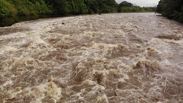 Aerial shot of Rio Quijos, Ecuador in flood, A tributary of the Amazon on the eastern slope of the Andes in Ecuador in flood after a tropical storm