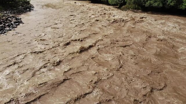 Aerial shot of Rio Quijos, Ecuador in flood, A tributary of the Amazon on the eastern slope of the Andes in Ecuador in flood after a tropical storm