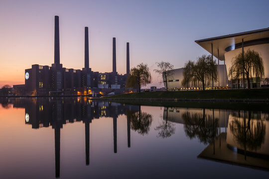 Volkswagen industrial skyline and Autostadt at dusk in Wolfsburg, Germany &mdash; calm evening view of the Volkswagen power plant with reflections in the water during blue hour in Lower Saxony.