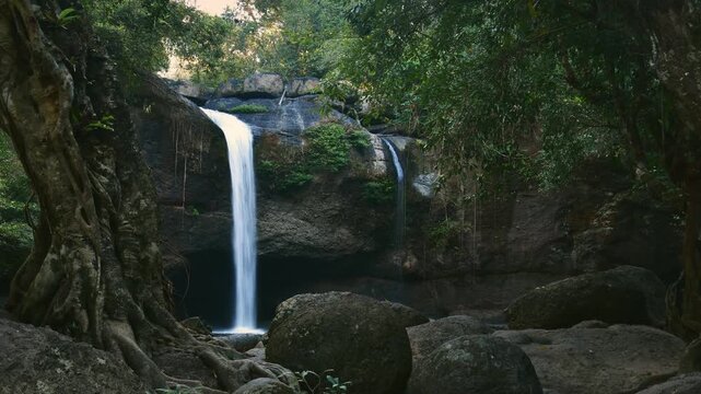 Timelapse zoom in Haew Suwat Waterfall Khao Yai National Park Thailand cascading through lush jungle greenery and ancient trees. Cinematic filter lush jungles asia ad promo background
