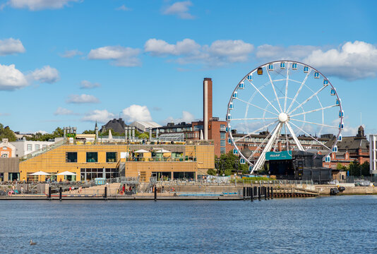 Helsinki, Finland - August 20, 2025: A picture of the Allas complex in Helsinki, with pools, restaurants and the SkyWheel.